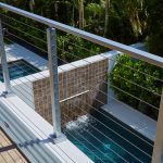 cable railing surface mount posts overlooking a beautiful pool in a Florida condo cable railing surface mount posts overlooking a beautiful pool in a Florida condo