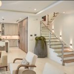 glass railing system with brushed stainless steel bump out posts and handrail